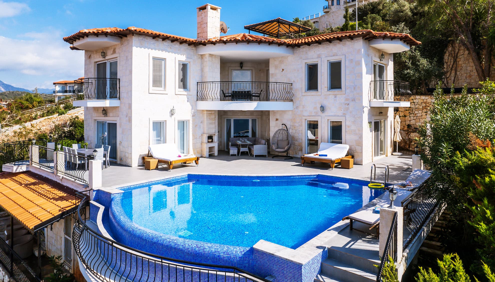 Spacious sun-drenched terrace with comfortable sun loungers next to the pool