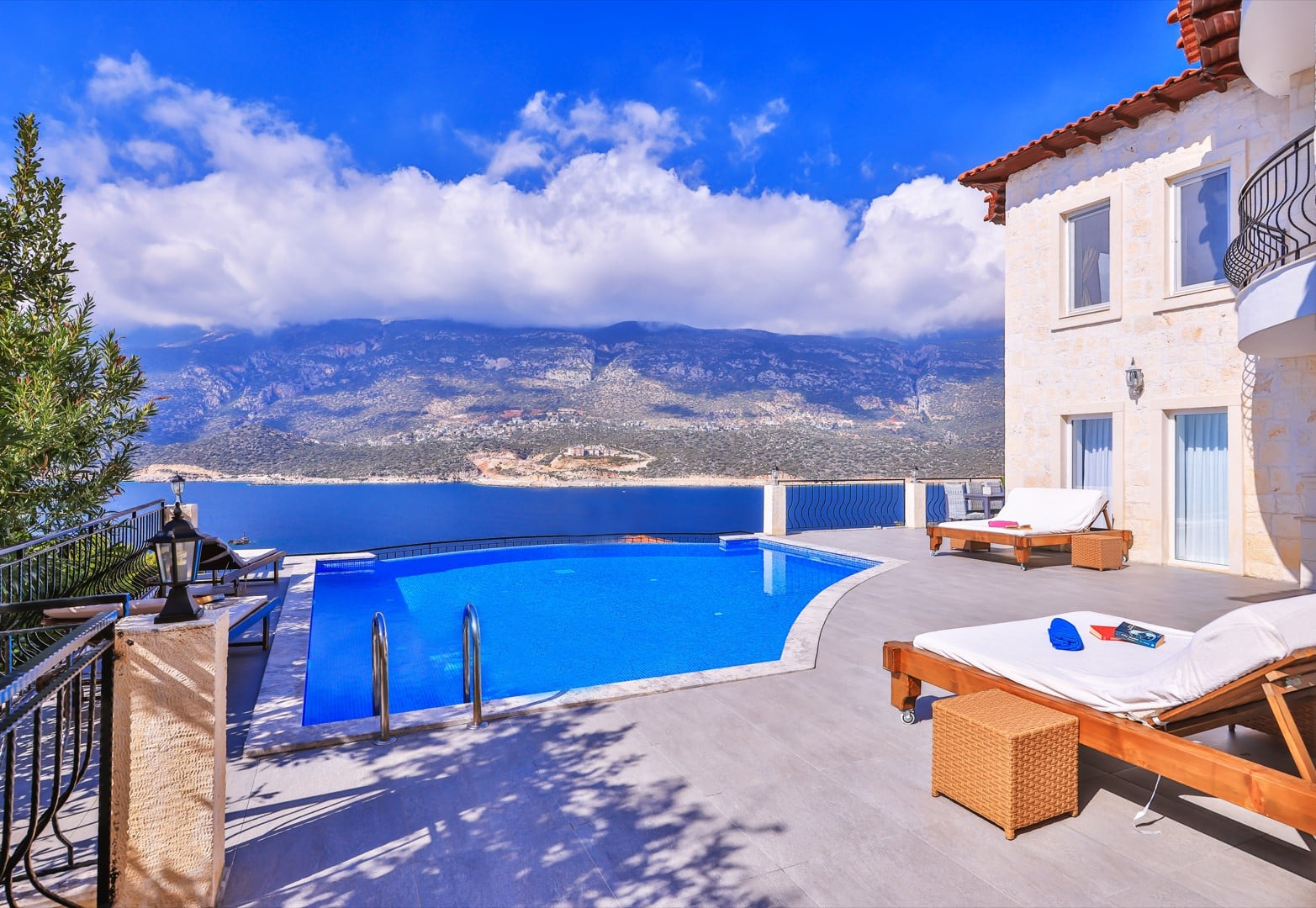 Modern open-plan living room with elegant sofas and large sea-view windows